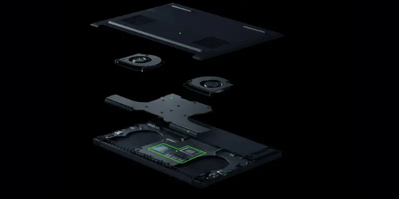 An exploded view of the internal components of a black Razer Blade laptop, showing the layered cooling system. It illustrates the bottom panel with vents, two cooling fans, a large vapor chamber or heatsink, and the main circuit board with the central processing unit (CPU) and graphics processing unit (GPU) highlighted in green