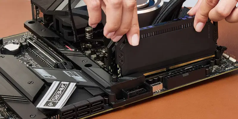 A Pair Of Hands Applying Firm Pressure To Install A Black Ram Stick Into A Dimm Slot On The Motherboard Next To The Cpu Cooler
